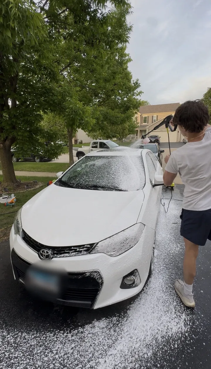 Michael-Christopher Suman washing the first car he detailed to raise funds for MCAS research